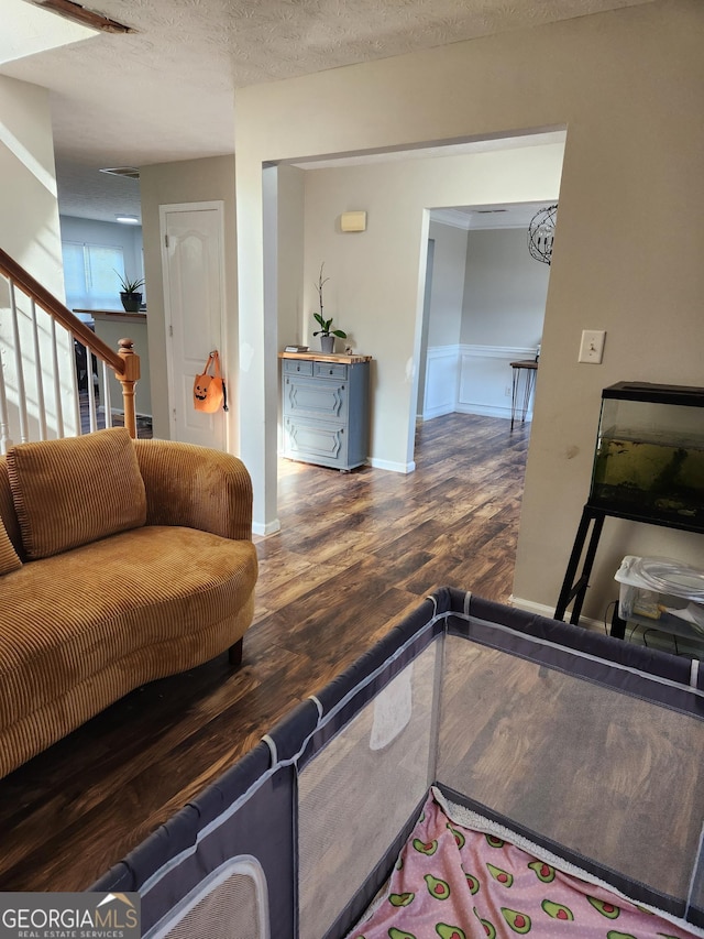 living room with dark wood-type flooring and a textured ceiling