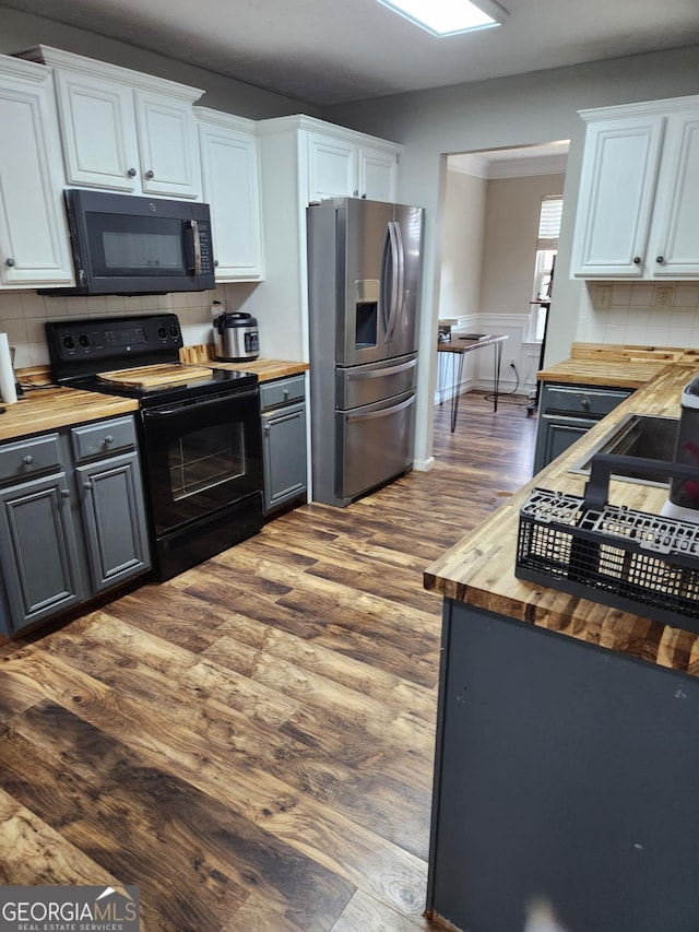 kitchen with white cabinetry, gray cabinets, butcher block counters, and black appliances