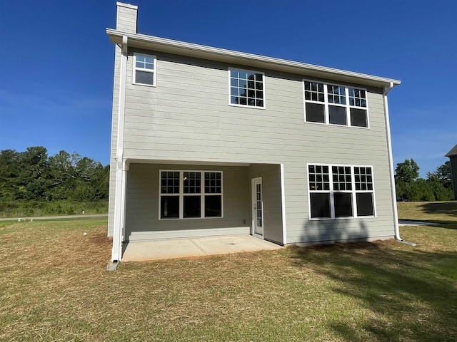 back of property featuring a yard and a patio area