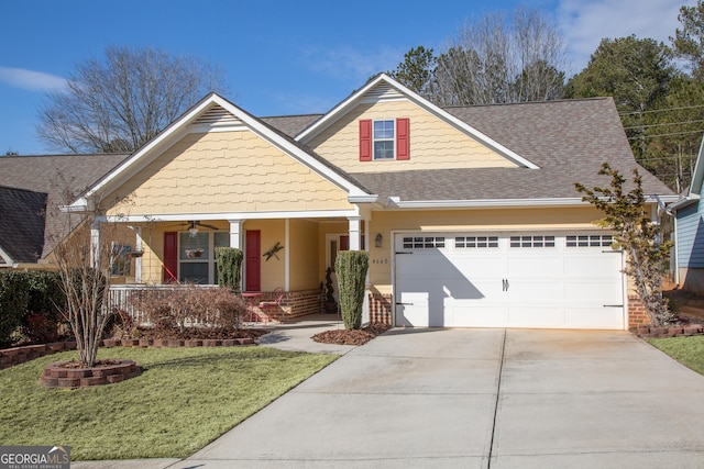 view of front facade featuring a garage, a front yard, and covered porch