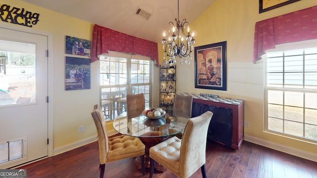 dining space featuring vaulted ceiling, dark hardwood / wood-style floors, and a notable chandelier