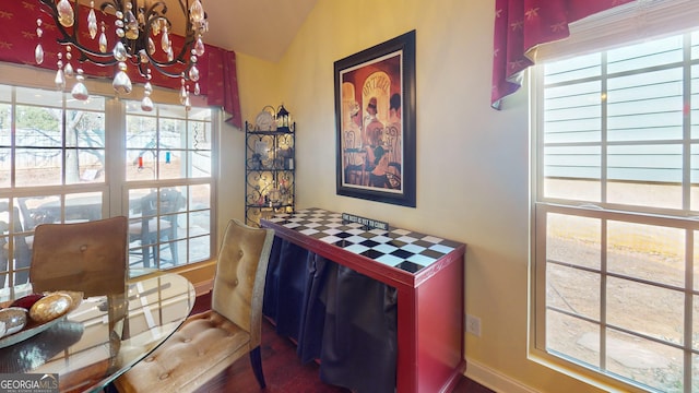 dining space featuring lofted ceiling and a chandelier