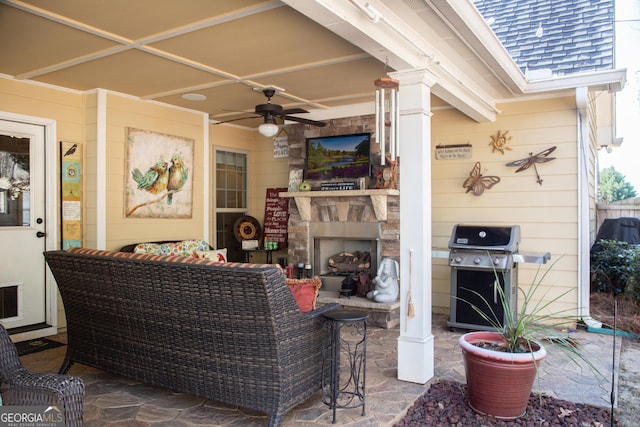 view of patio / terrace with a grill, an outdoor living space with a fireplace, and ceiling fan