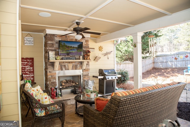 view of patio with an outdoor living space with a fireplace, grilling area, and ceiling fan