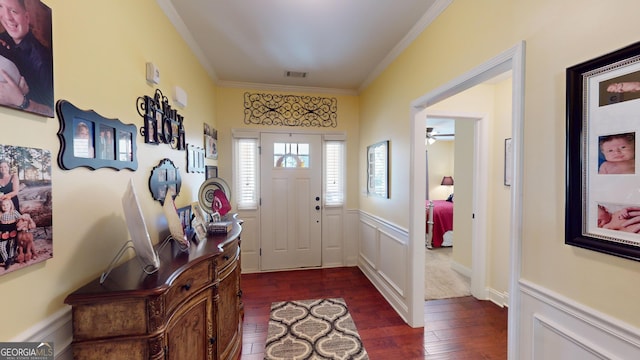 entryway with crown molding and dark wood-type flooring