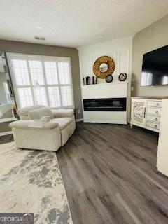 unfurnished living room with dark wood-type flooring