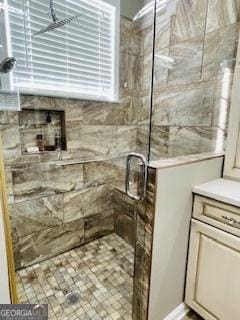 bathroom with vanity and a shower with shower door