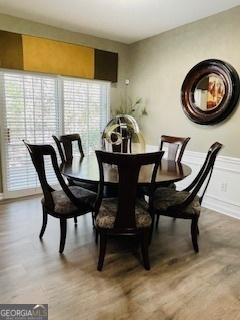 dining room with a healthy amount of sunlight and hardwood / wood-style floors