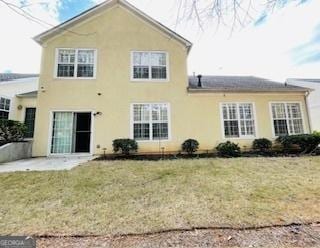 back of house featuring a yard and a patio area