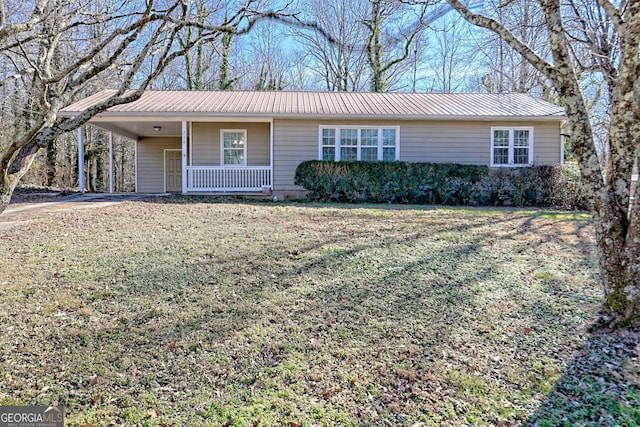 ranch-style house featuring covered porch and a front lawn