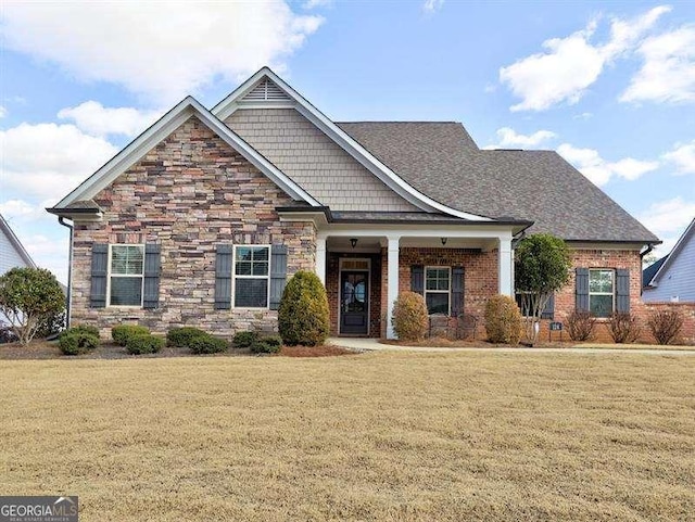 craftsman-style home with a front yard