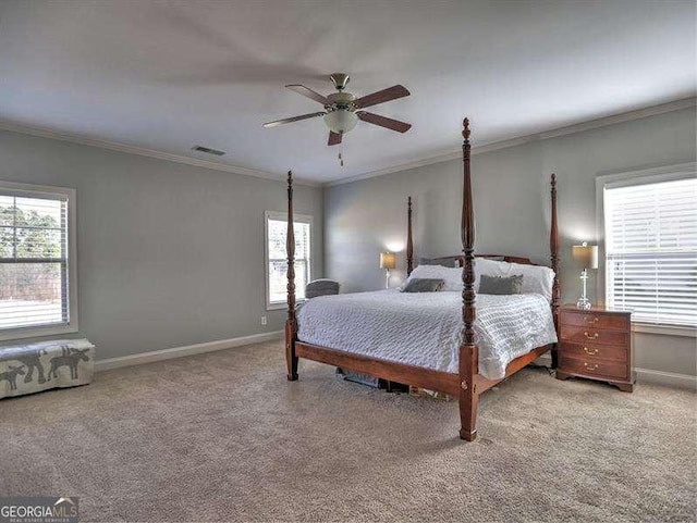 carpeted bedroom with crown molding and ceiling fan