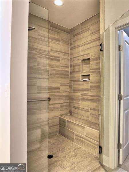 bathroom with a shower with shower door