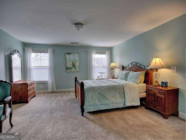 bedroom featuring light colored carpet