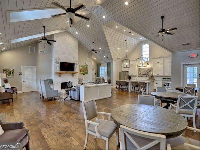 dining area with wood ceiling, a healthy amount of sunlight, and high vaulted ceiling