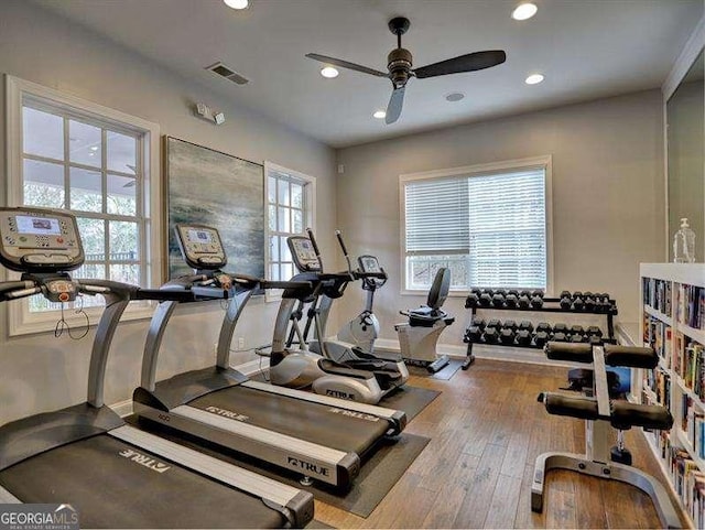 workout area featuring wood-type flooring and ceiling fan