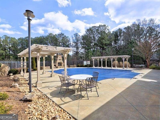 view of pool with a pergola and a patio area