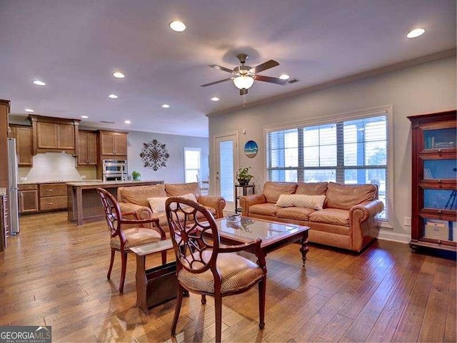 living room featuring plenty of natural light, dark hardwood / wood-style floors, and ceiling fan