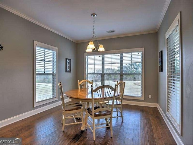 dining area with crown molding, dark hardwood / wood-style flooring, and a wealth of natural light