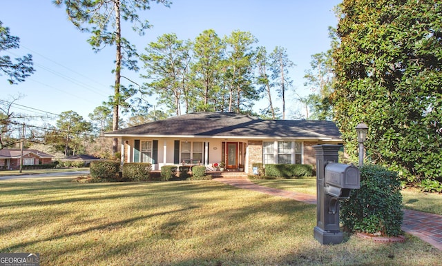 single story home with a porch and a front yard