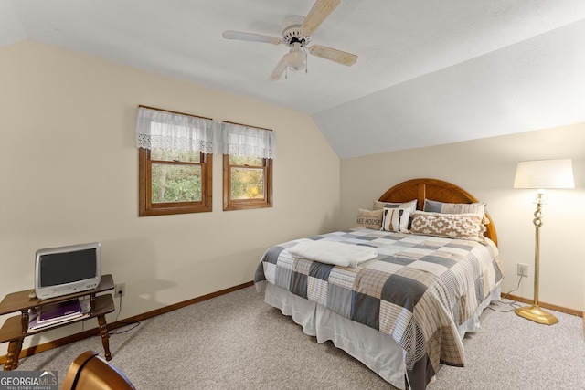 carpeted bedroom with ceiling fan and lofted ceiling