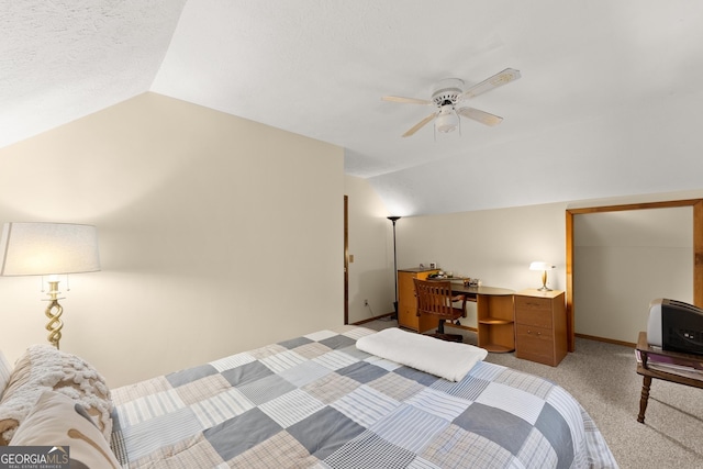 carpeted bedroom with vaulted ceiling and ceiling fan