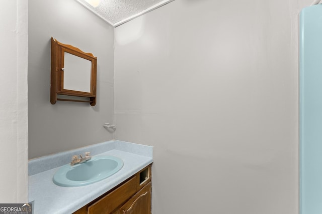 bathroom featuring vanity and a textured ceiling