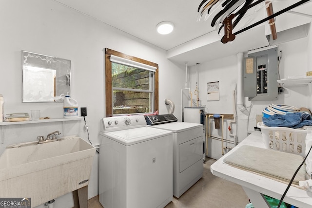 laundry room featuring washing machine and clothes dryer, sink, and electric panel