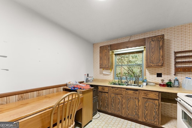 kitchen featuring sink and white range with electric cooktop