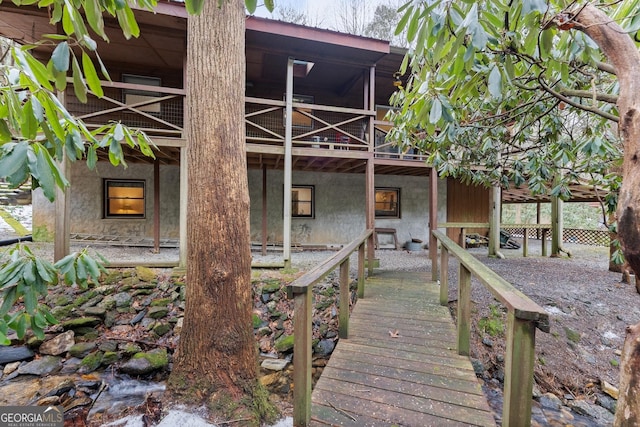 rear view of property featuring a balcony