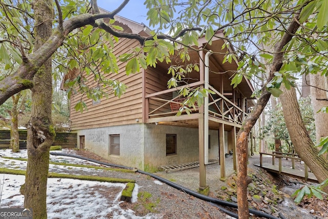 snow covered property with a deck