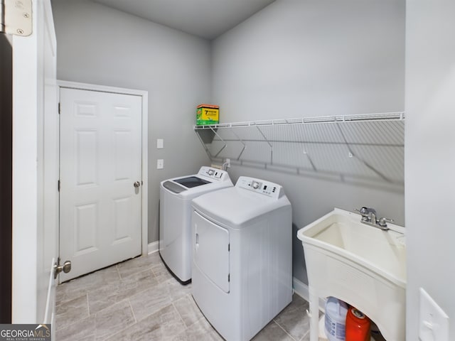 laundry room featuring washing machine and dryer and sink