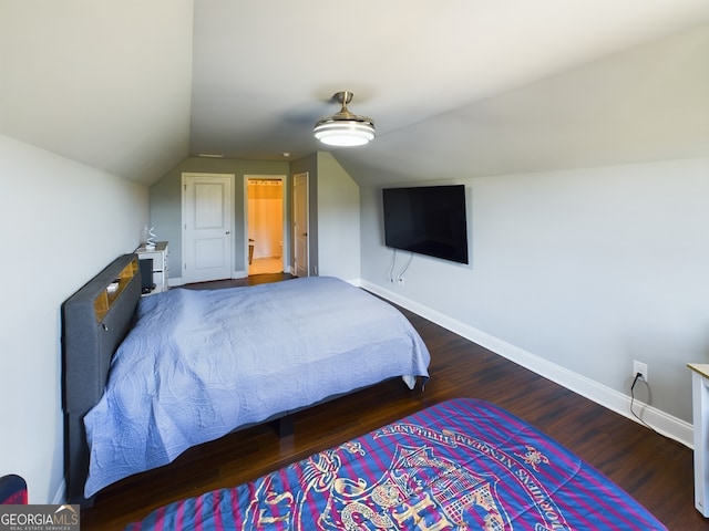 bedroom featuring hardwood / wood-style flooring and lofted ceiling