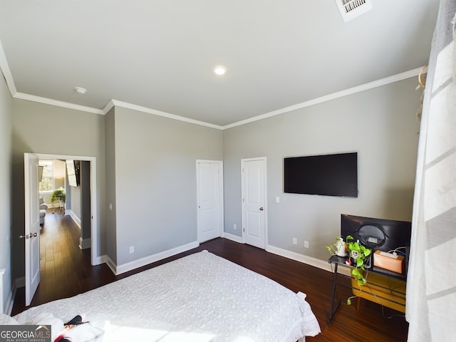 bedroom featuring crown molding and dark hardwood / wood-style floors