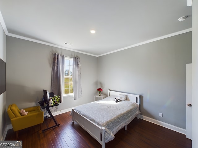 bedroom with crown molding and dark hardwood / wood-style flooring