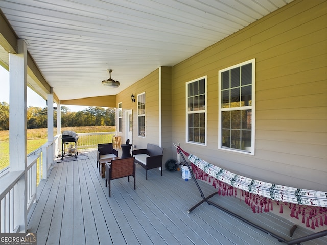 deck featuring a grill, outdoor lounge area, and a porch