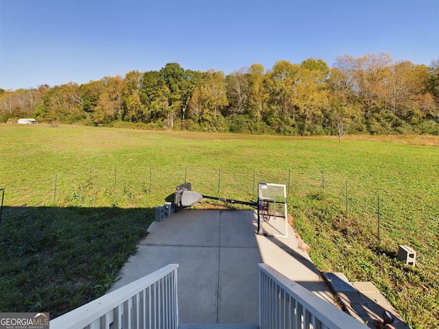 view of yard with a rural view and a patio