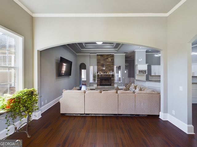 unfurnished living room featuring plenty of natural light and dark hardwood / wood-style floors