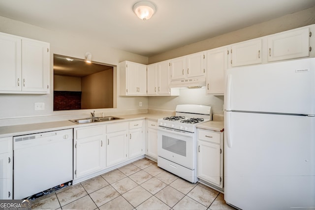 kitchen featuring white appliances, light tile patterned floors, sink, and white cabinets