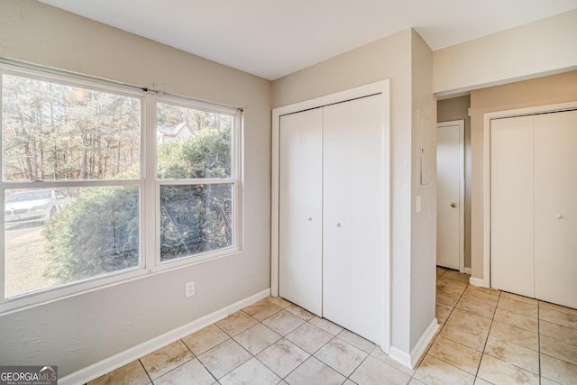 unfurnished bedroom with light tile patterned floors