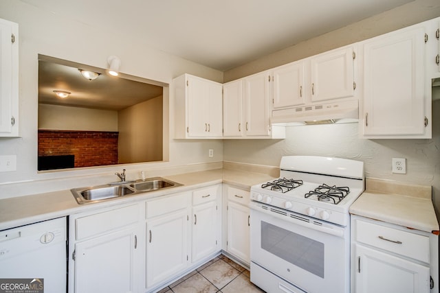 kitchen with white cabinetry, sink, light tile patterned floors, and white appliances