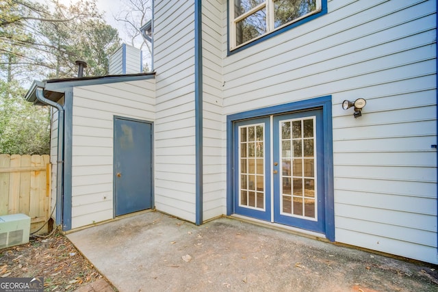 property entrance with a patio and french doors