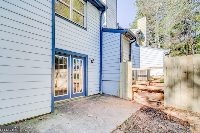 exterior space with french doors and central AC unit