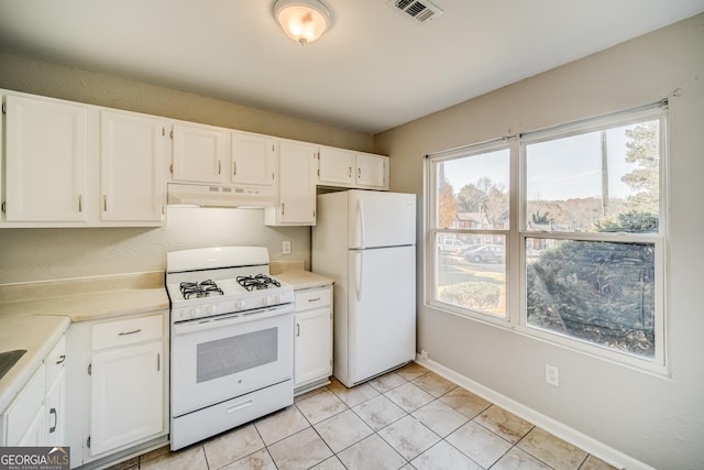 kitchen featuring white cabinetry, white appliances, and light tile patterned flooring