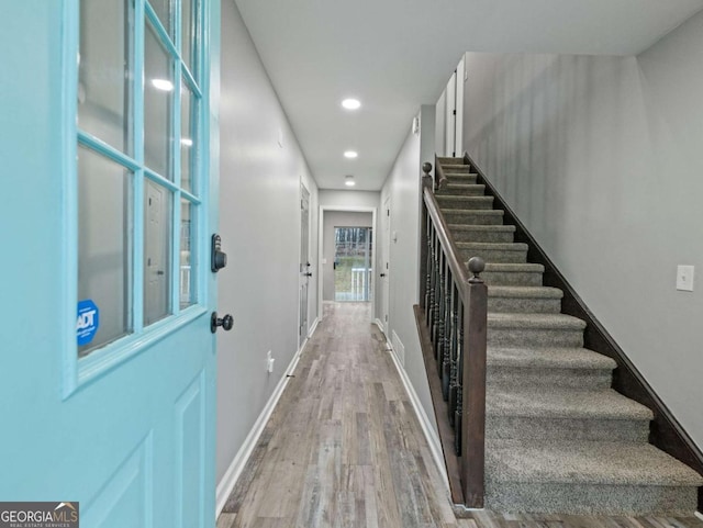 stairway with hardwood / wood-style flooring