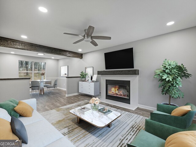 unfurnished living room featuring beam ceiling, wood-type flooring, and ceiling fan