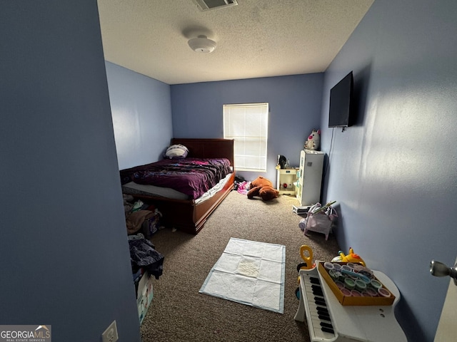 carpeted bedroom with a textured ceiling