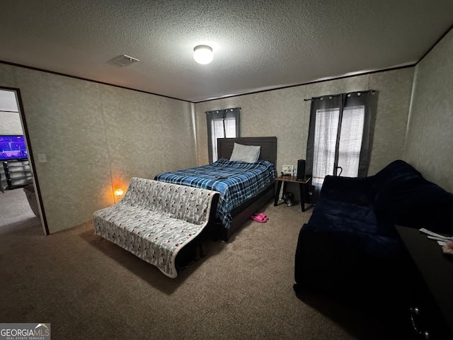 bedroom featuring crown molding, carpet flooring, and a textured ceiling