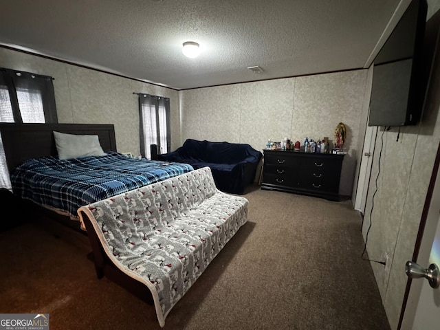 bedroom featuring crown molding, carpet floors, and a textured ceiling