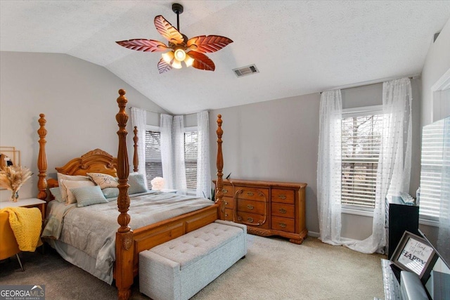 carpeted bedroom featuring lofted ceiling, a textured ceiling, and ceiling fan